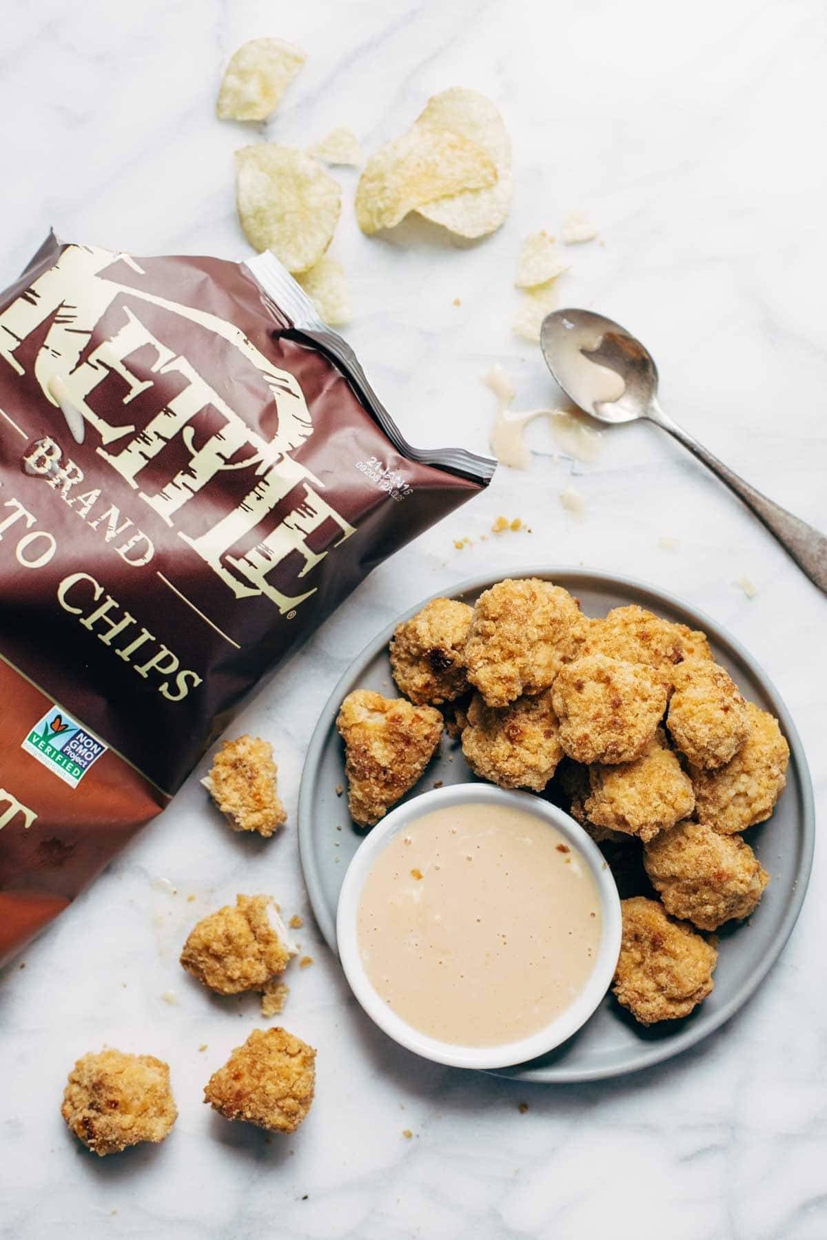 Everyone LOVES these! Baked popcorn chicken that tastes fried! Easy recipe, ready in 30 minutes. SO yummy and fun to share! | pinchofyum.com