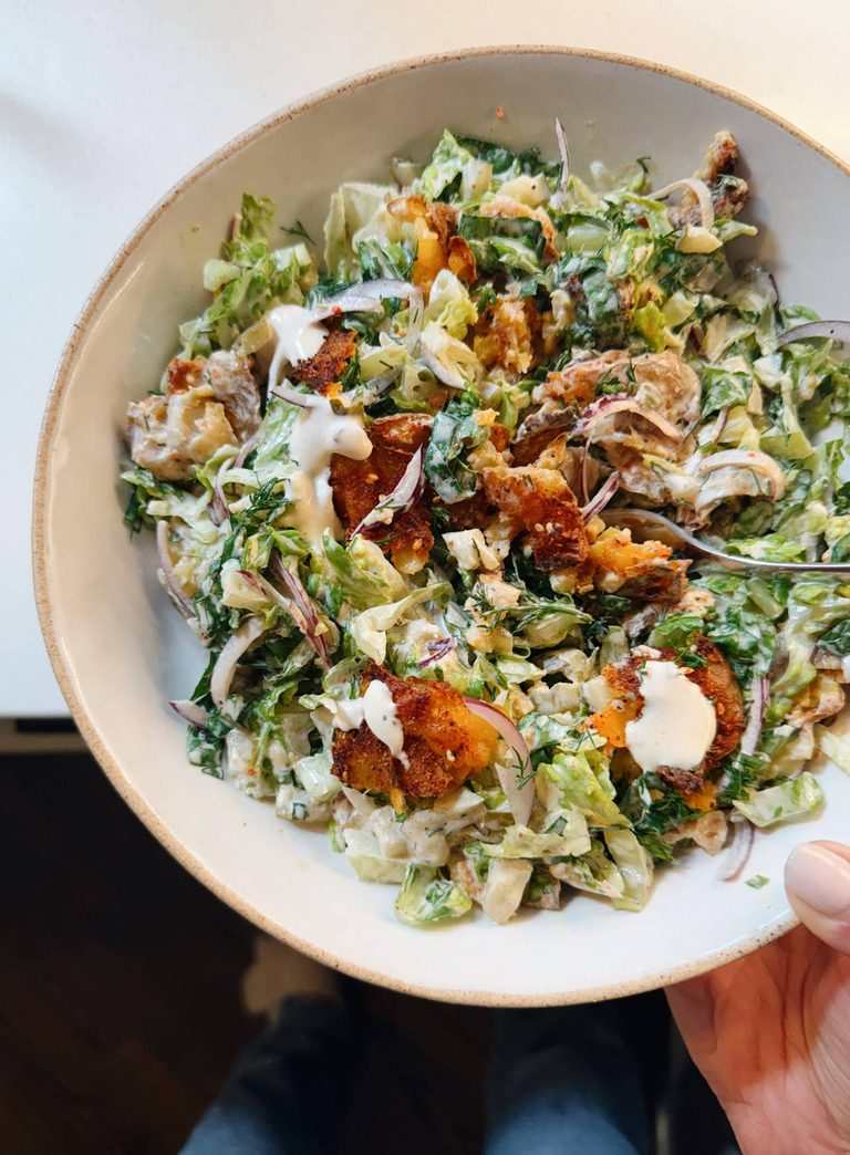 Crispy smashed potato salad in a bowl.